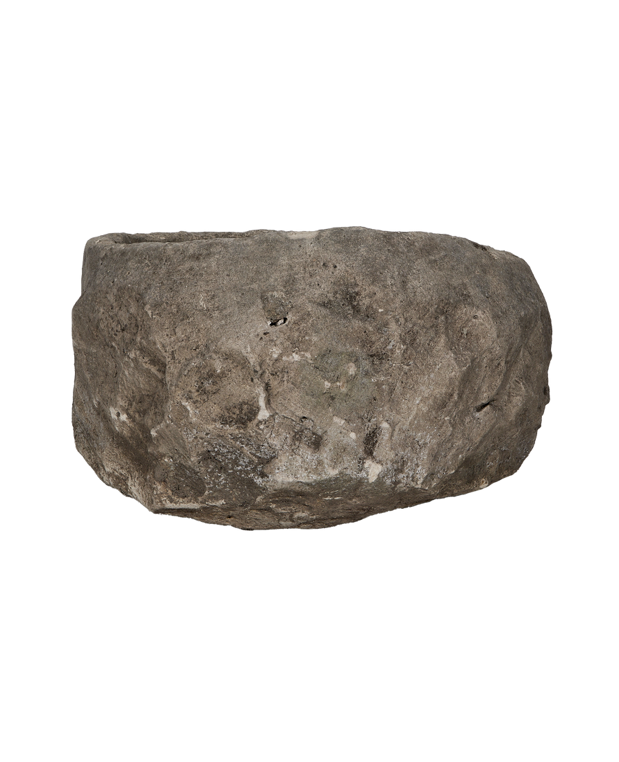 Vintage Indonesian round limestone trough, side profile, revealing natural rough texture and weathered finish.