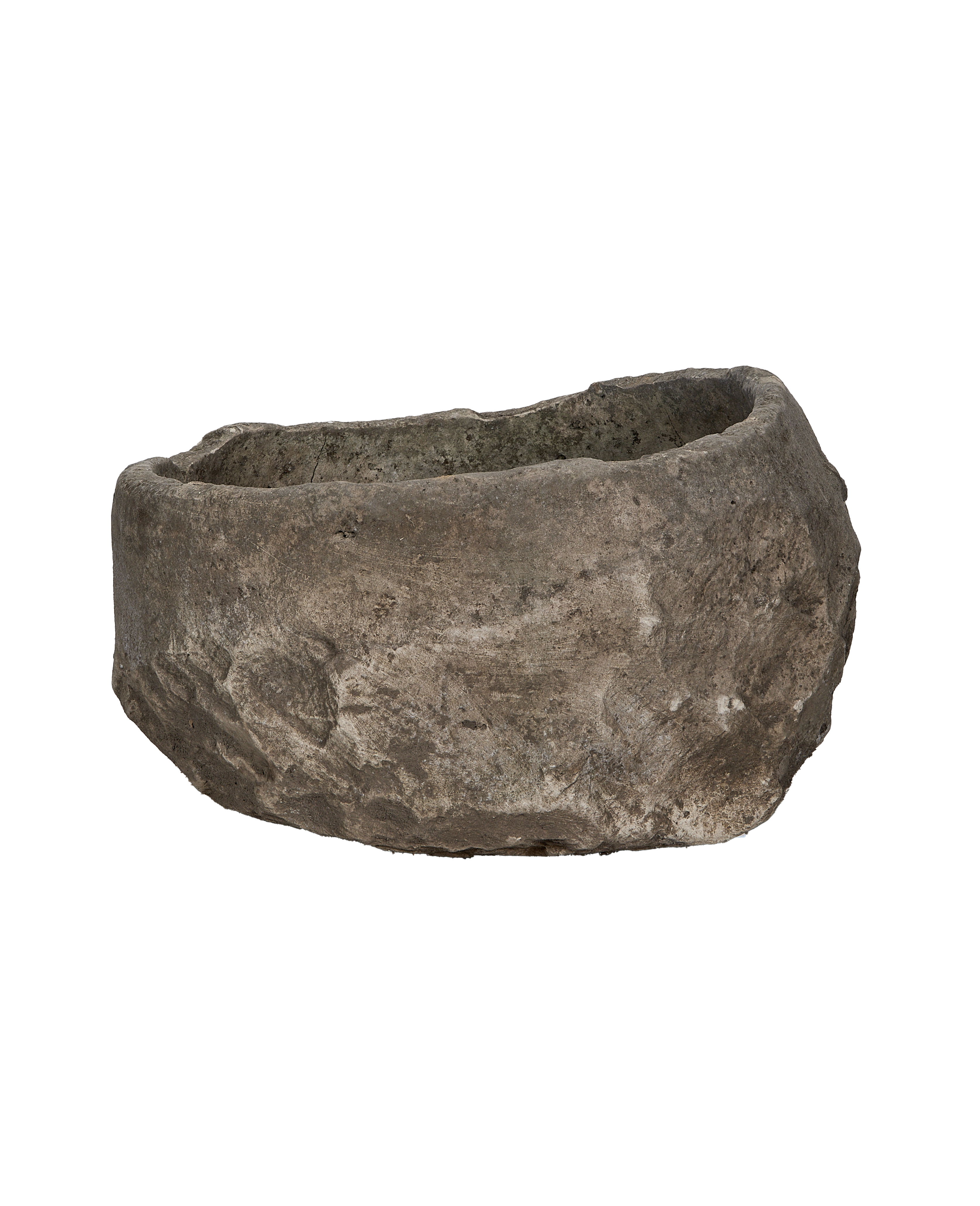 Vintage Indonesian limestone trough, showing the rustic cracked texture and uneven rim.