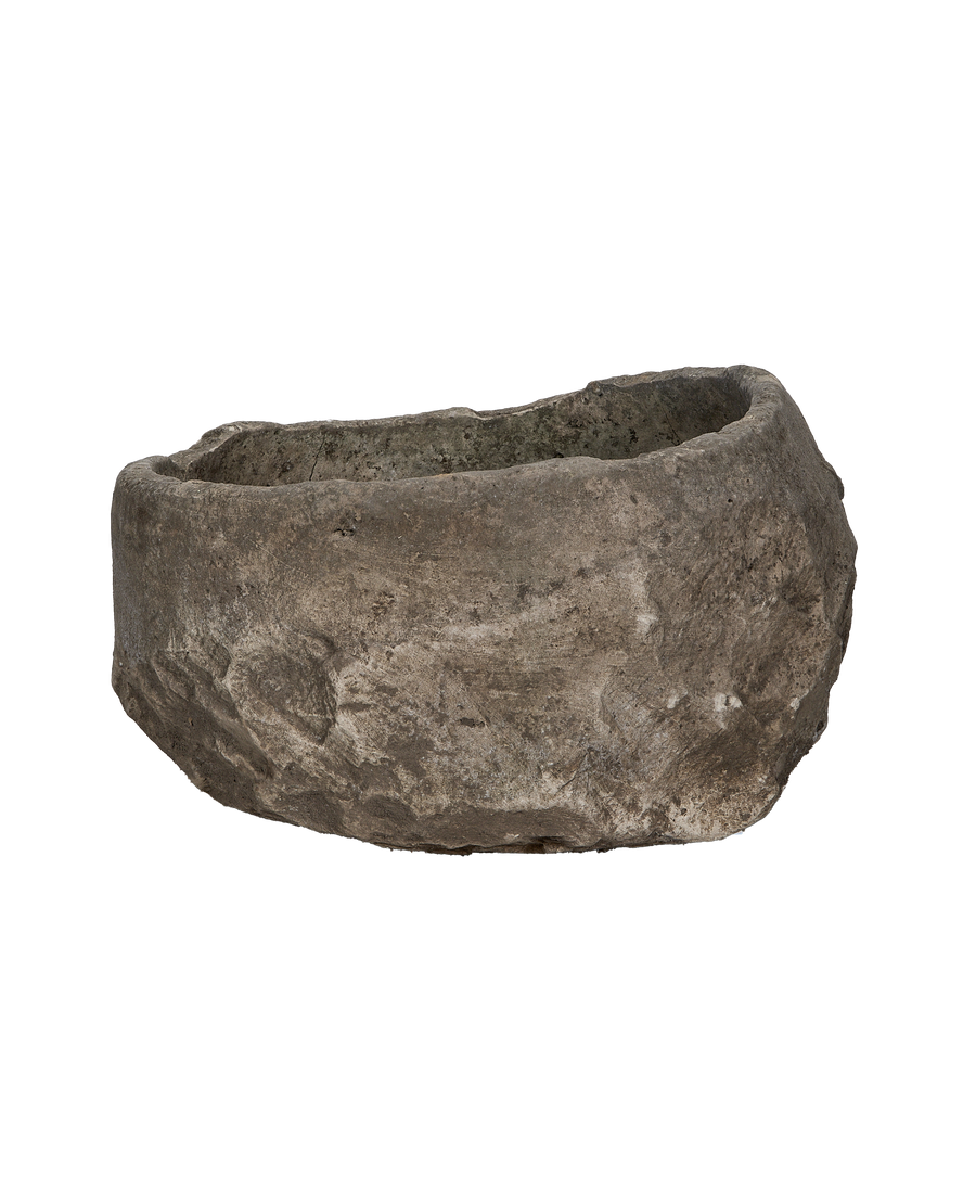 Vintage Indonesian limestone trough, showing the rustic cracked texture and uneven rim.