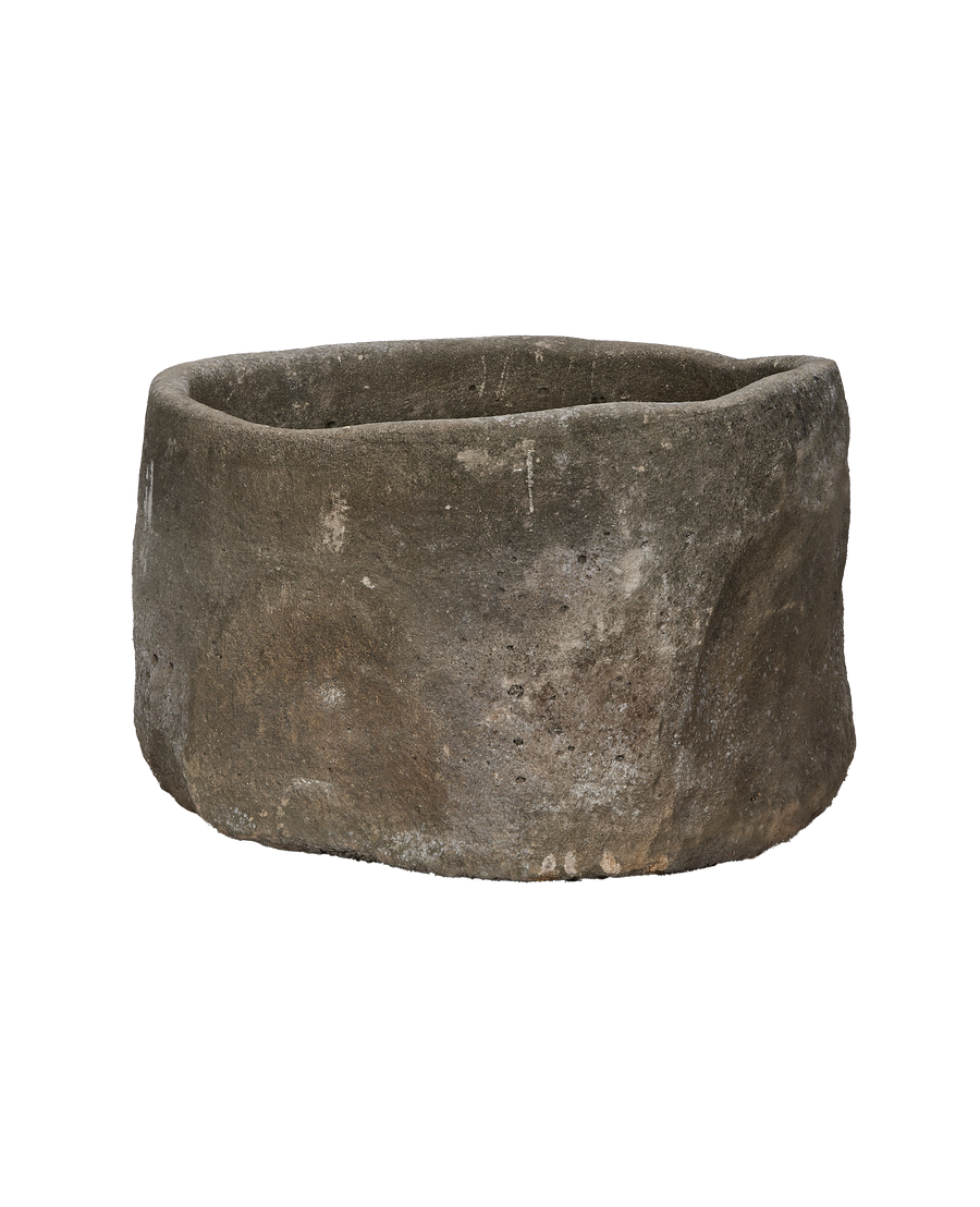 Vintage Indonesian limestone trough, round, rugged texture, showing natural aging and unique imperfections.