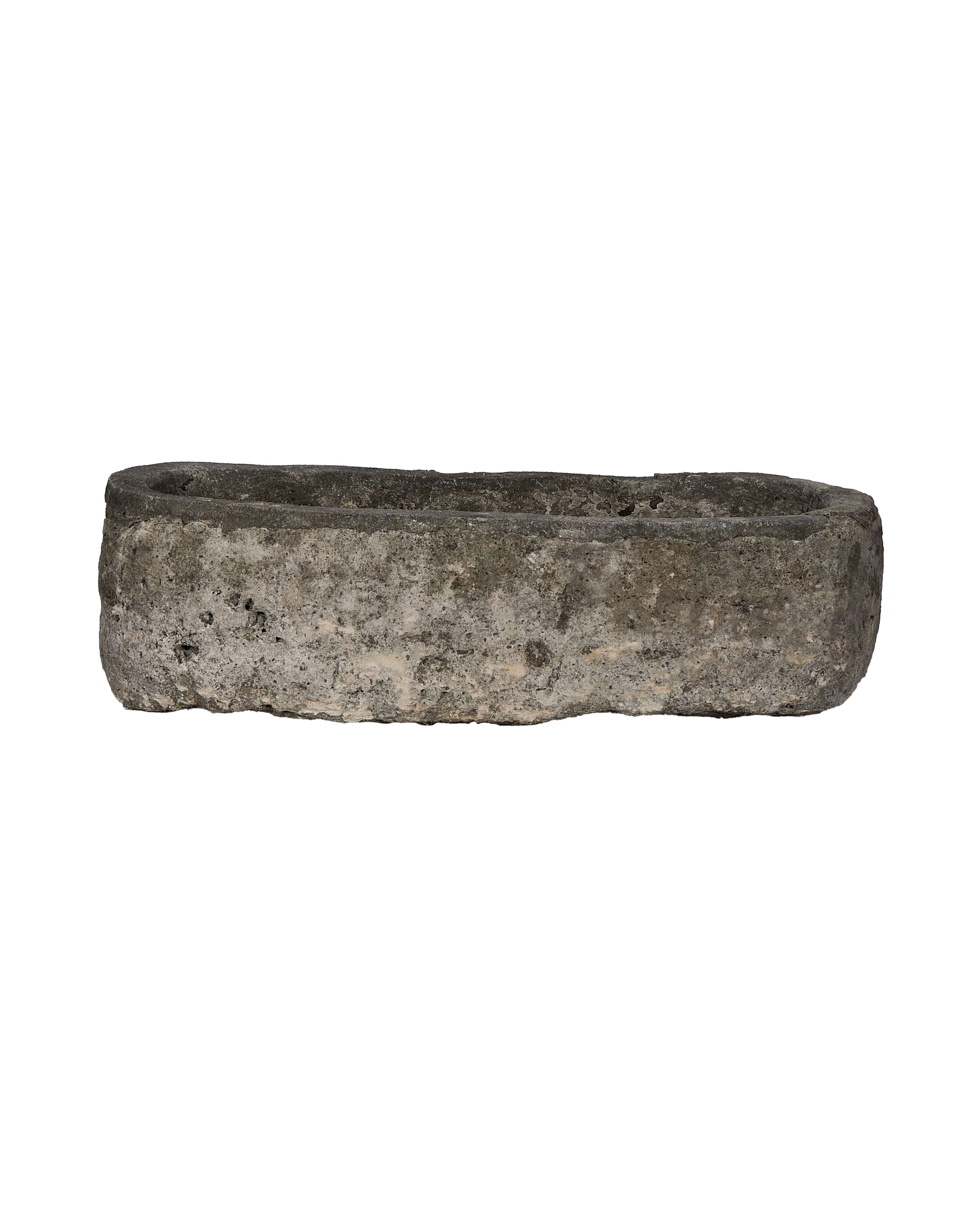 Vintage, oblong limestone trough from Indonesia, featuring rustic rough texture and natural dark patina.