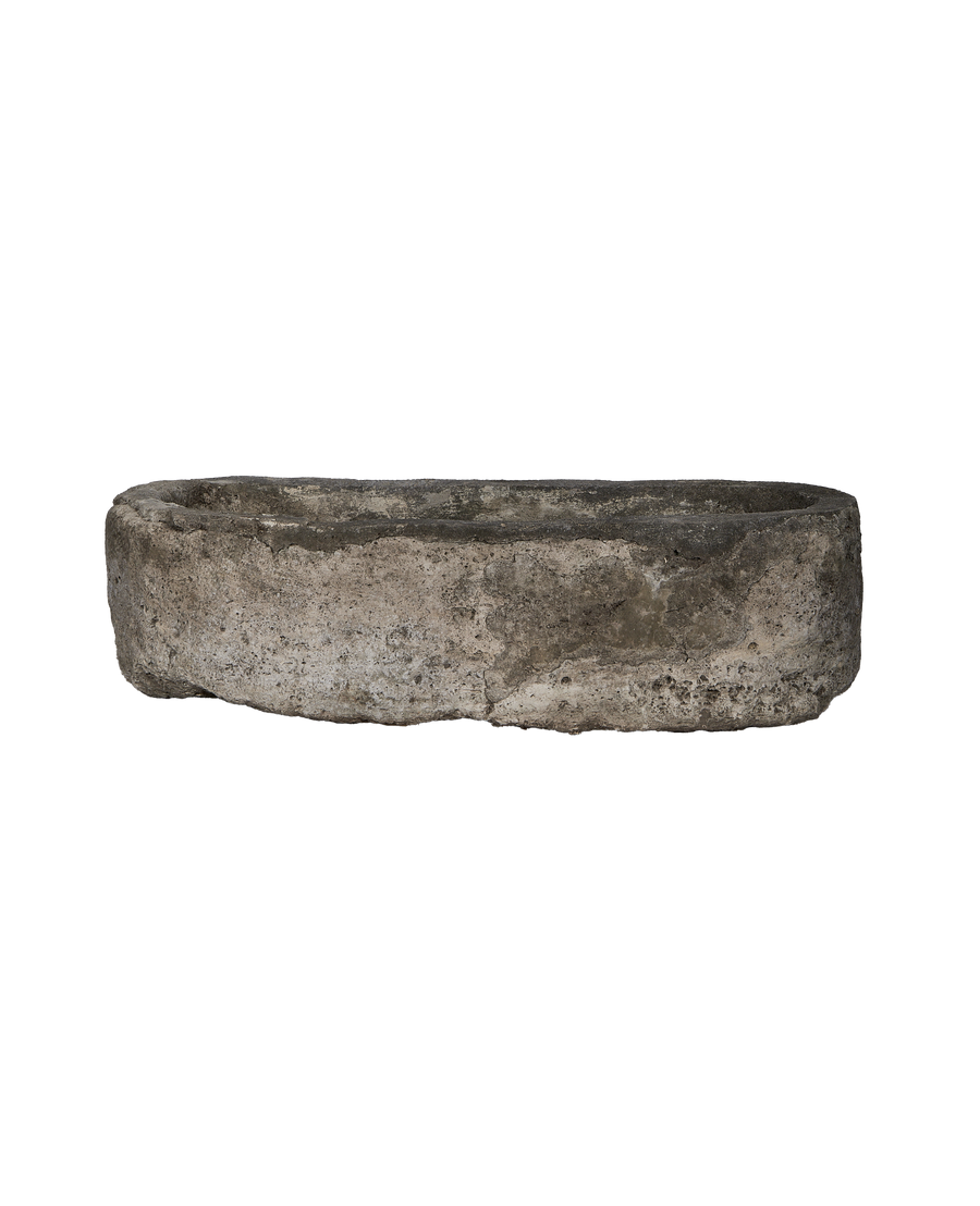 Vintage Indonesian oblong limestone trough, detailed side view, showing weathered surface.