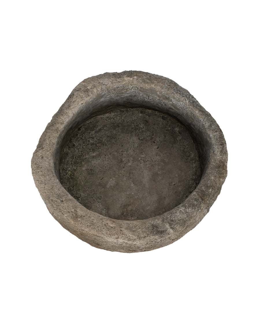 Vintage Indonesian limestone trough, top-down view showing weathered, textured interior and rim.