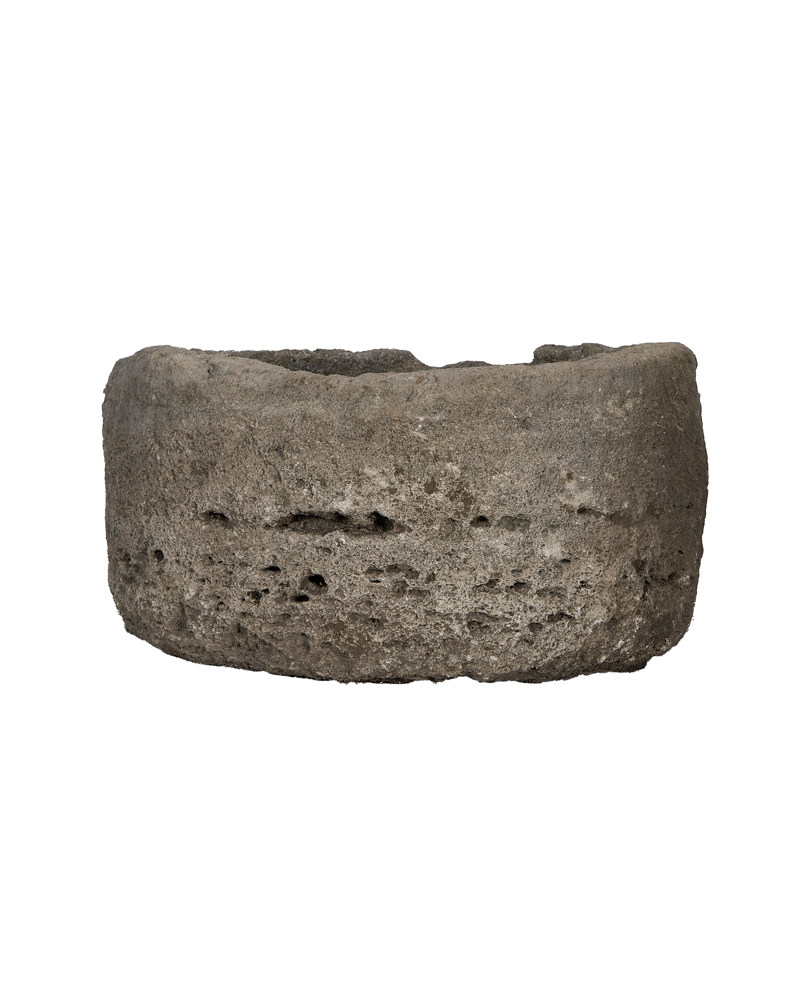 Vintage round limestone trough, showing porous texture and weathered Indonesian stone.