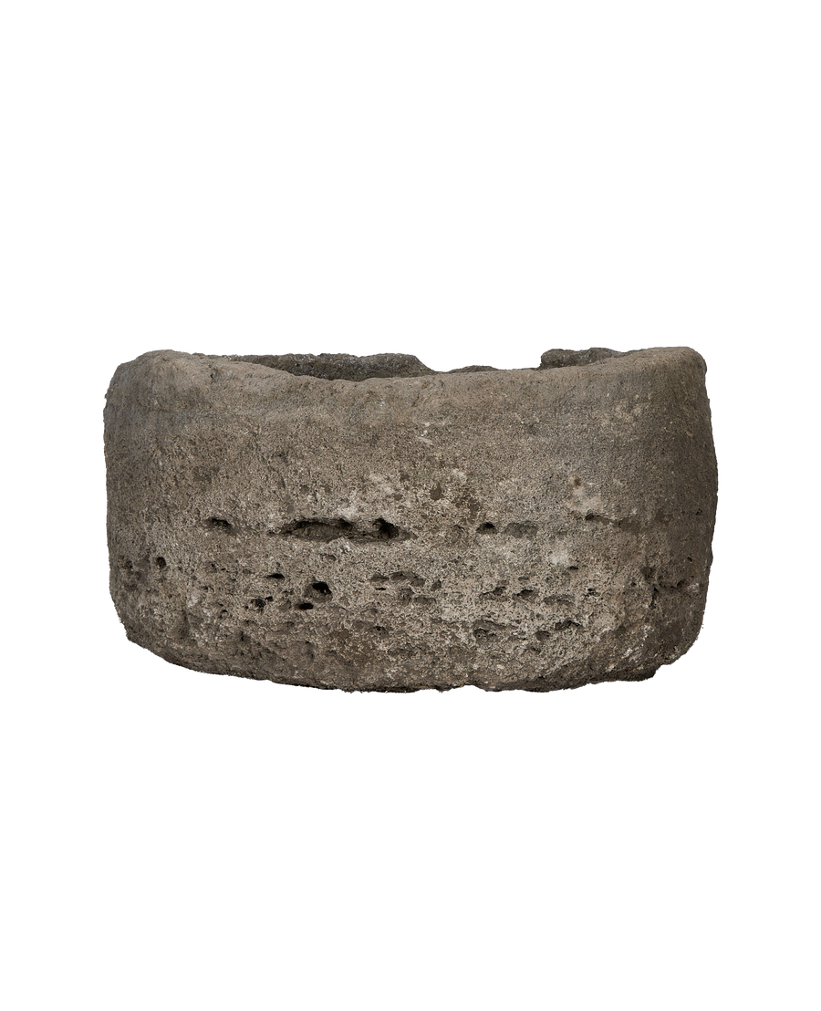 Vintage round limestone trough, showing porous texture and weathered Indonesian stone.
