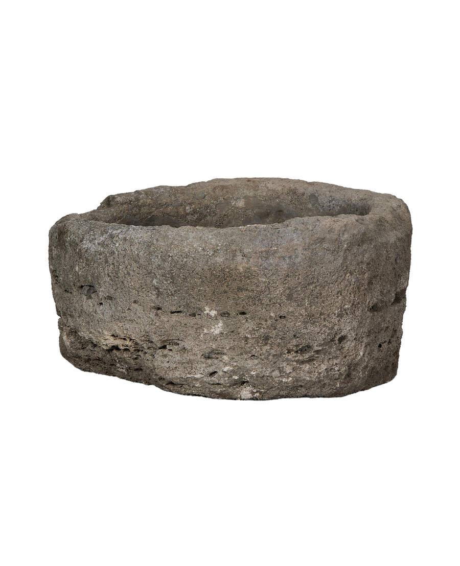 Vintage Indonesian round limestone trough, showing weathered texture and natural imperfections.