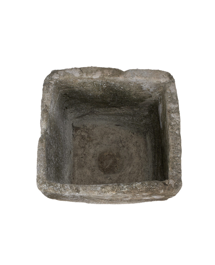 Vintage Indonesian limestone trough, top-down view highlighting the weathered interior texture.