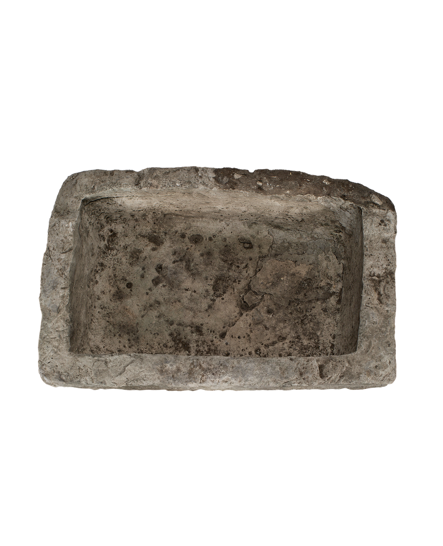 Vintage Indonesian limestone trough, top-down view showing deep rectangular basin and rough texture.