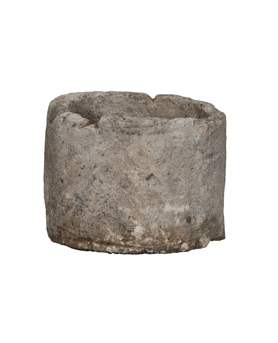Vintage Indonesian limestone trough (OAK), round, showing the rough, weathered texture and uneven rim.