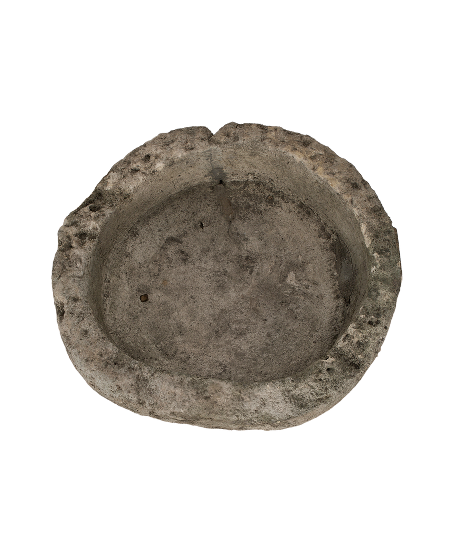 Vintage round limestone trough from Indonesia, top view showing weathered interior texture.