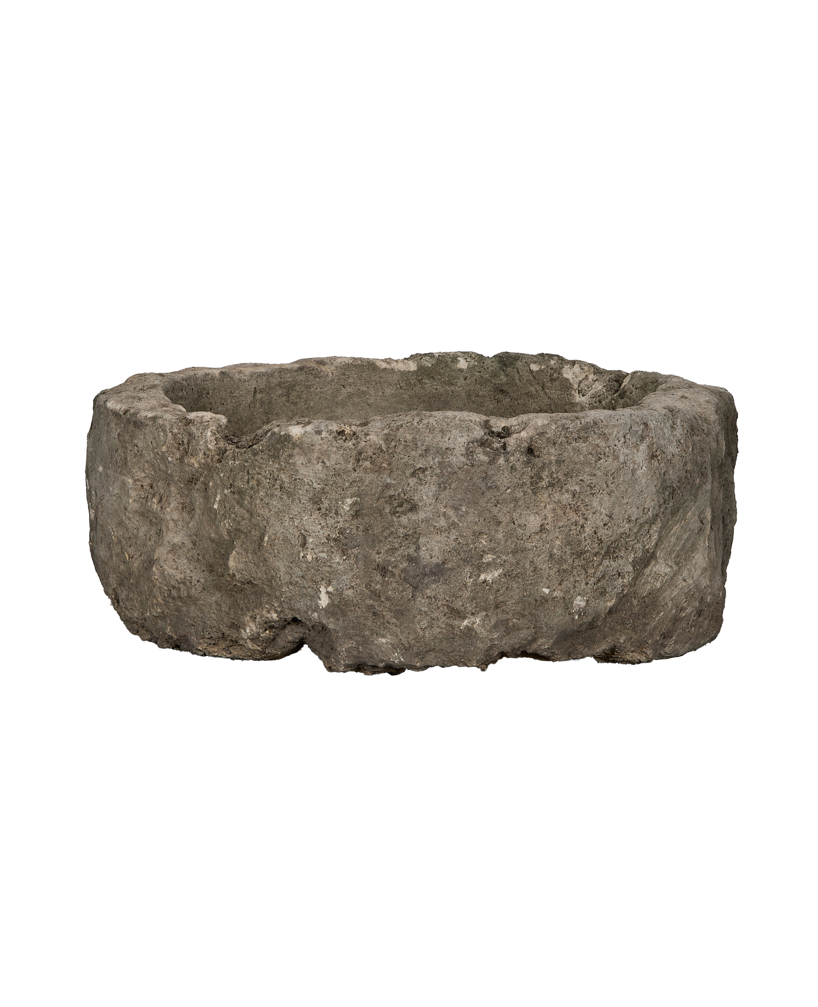 Vintage Indonesian round limestone trough, side profile, revealing rough natural texture.