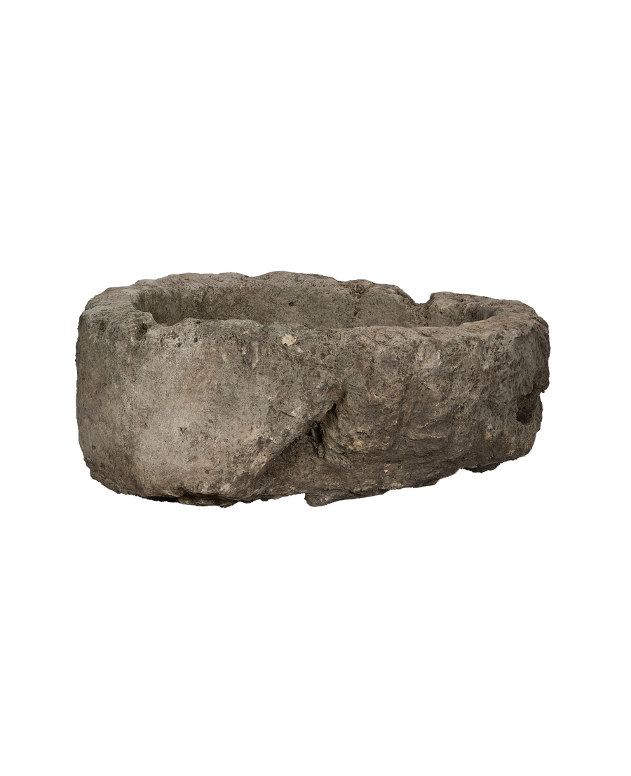 Vintage Indonesian naturally weathered limestone trough, showing a side view with texture.