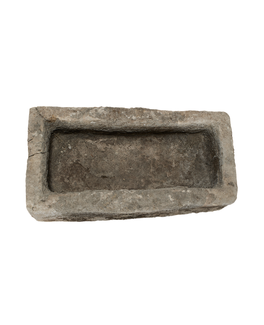 Vintage Indonesian limestone trough, top view inside showing aged, textured surface.