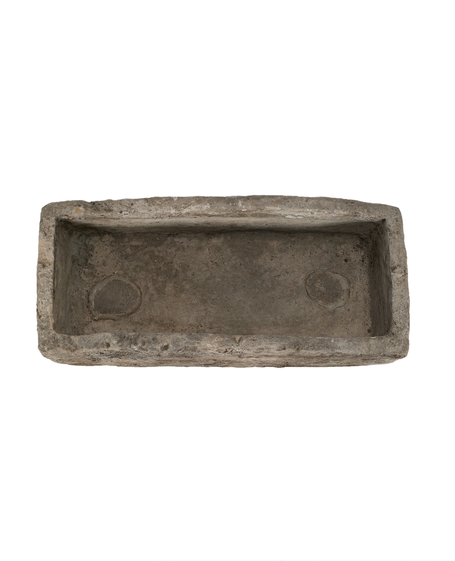 Vintage Indonesian limestone trough, top-down view showing interior rectangular basin with rounded drainage spots.