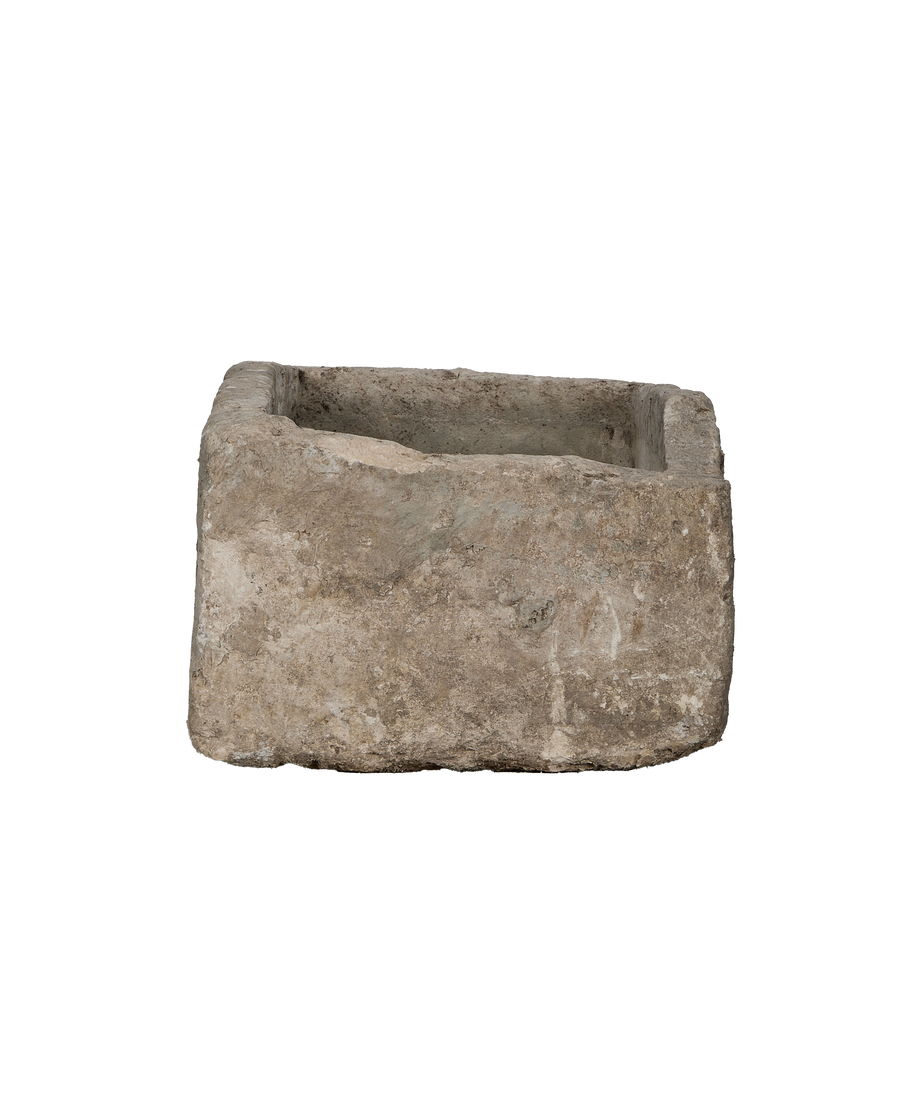 Vintage Indonesian limestone trough viewed from 3/4 angle, showing its rugged texture.