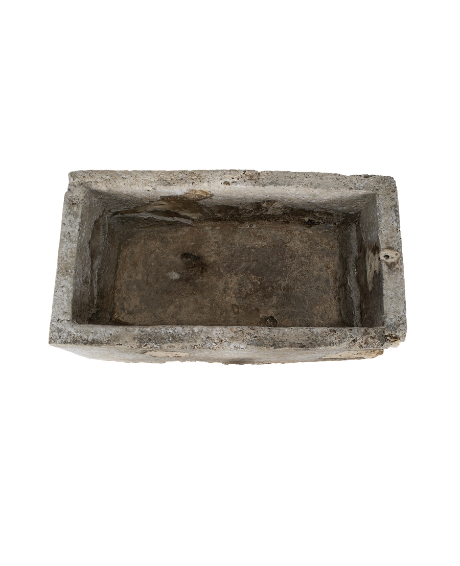 Vintage limestone trough from Indonesia, weathered interior texture, aerial view.