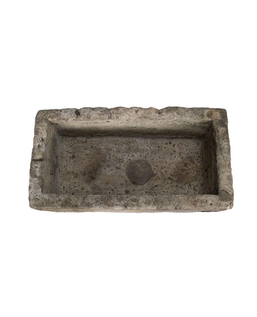 Vintage rectangular Indonesian limestone trough, top-down view showing interior texture and weathered surface.