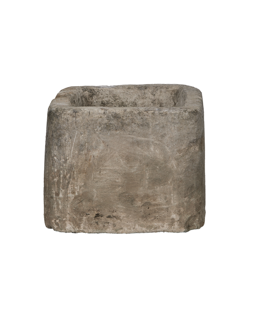 Vintage Indonesian limestone trough, rectangle shape, showing textured sideview and worn edges.