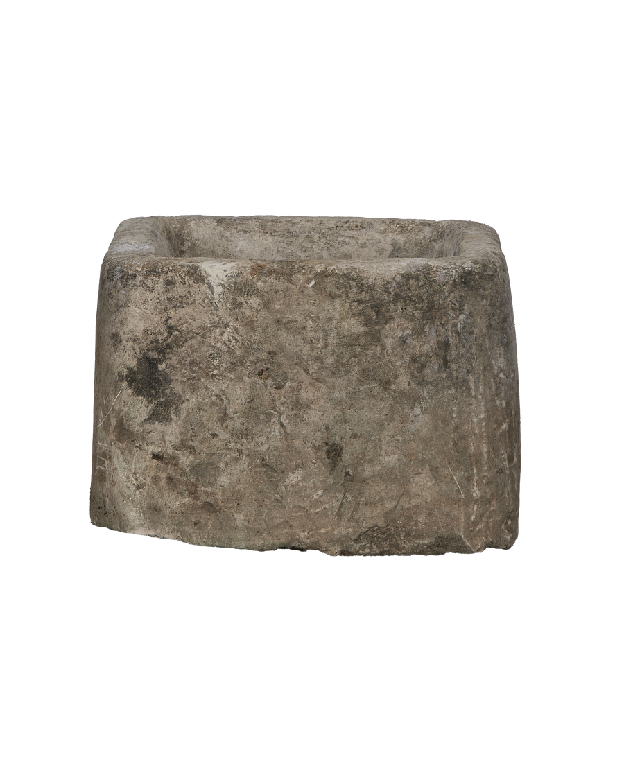 Vintage Indonesian rectangular limestone trough, close-up of rough, weathered texture and imperfections.