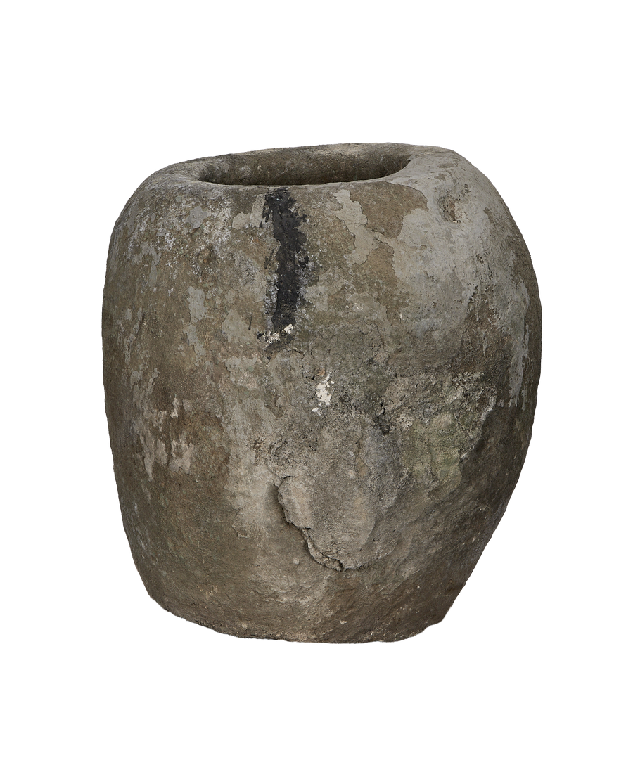 Vintage Indonesian limestone trough, round, showing weathered gray-black surface texture detail.