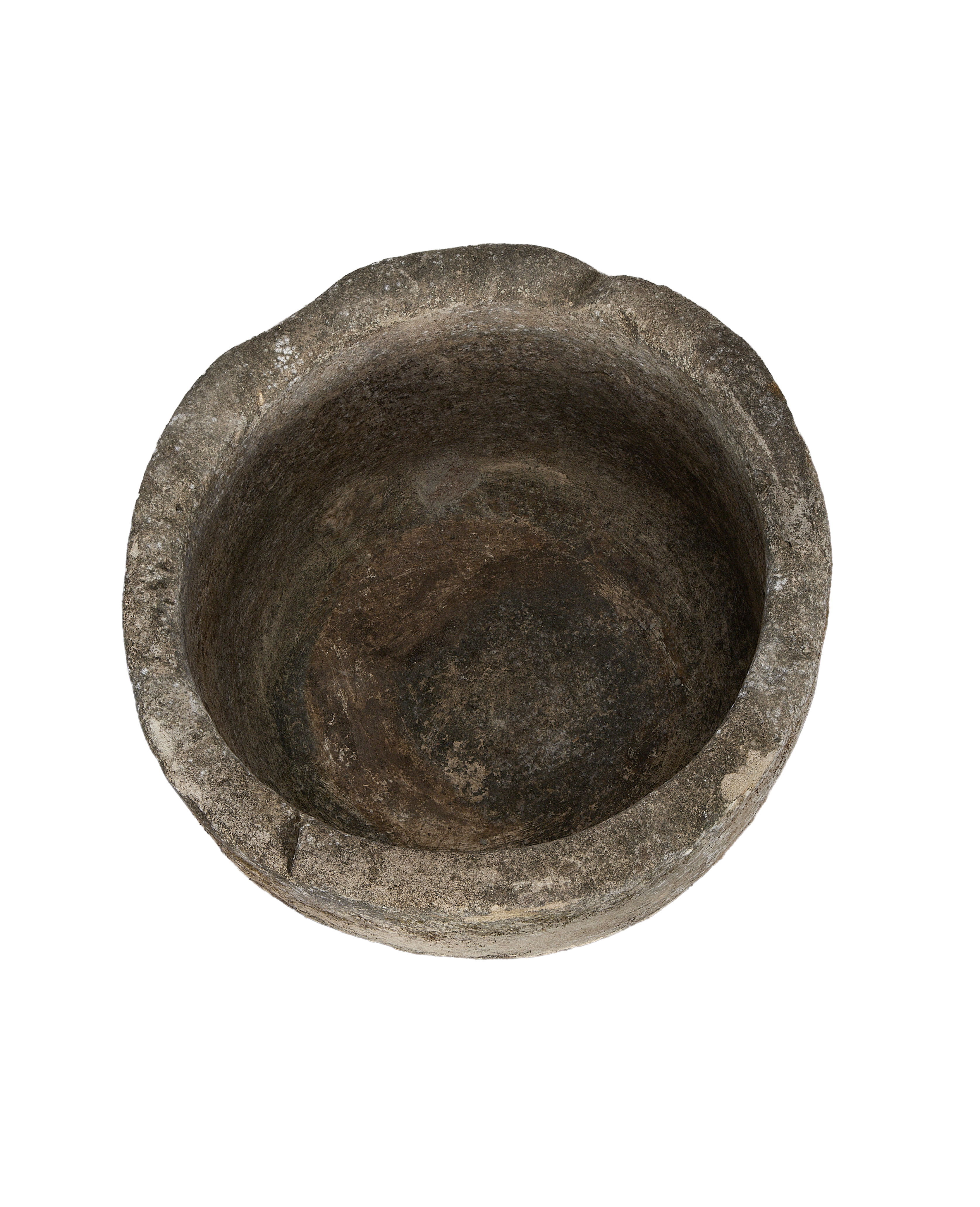 Overhead shot of vintage Indonesian limestone trough interior, showing worn, textured surface.