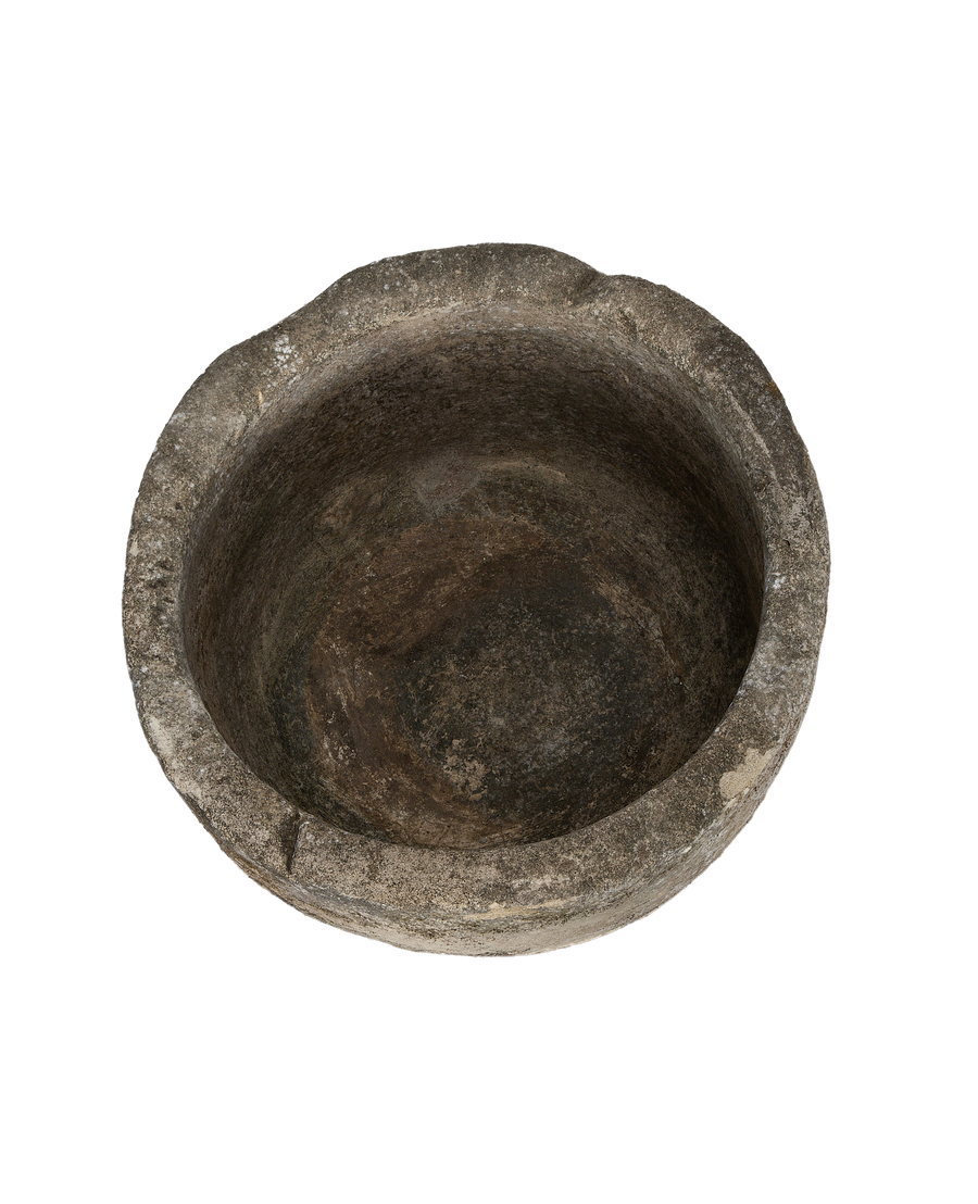 Overhead shot of vintage Indonesian limestone trough interior, showing worn, textured surface.