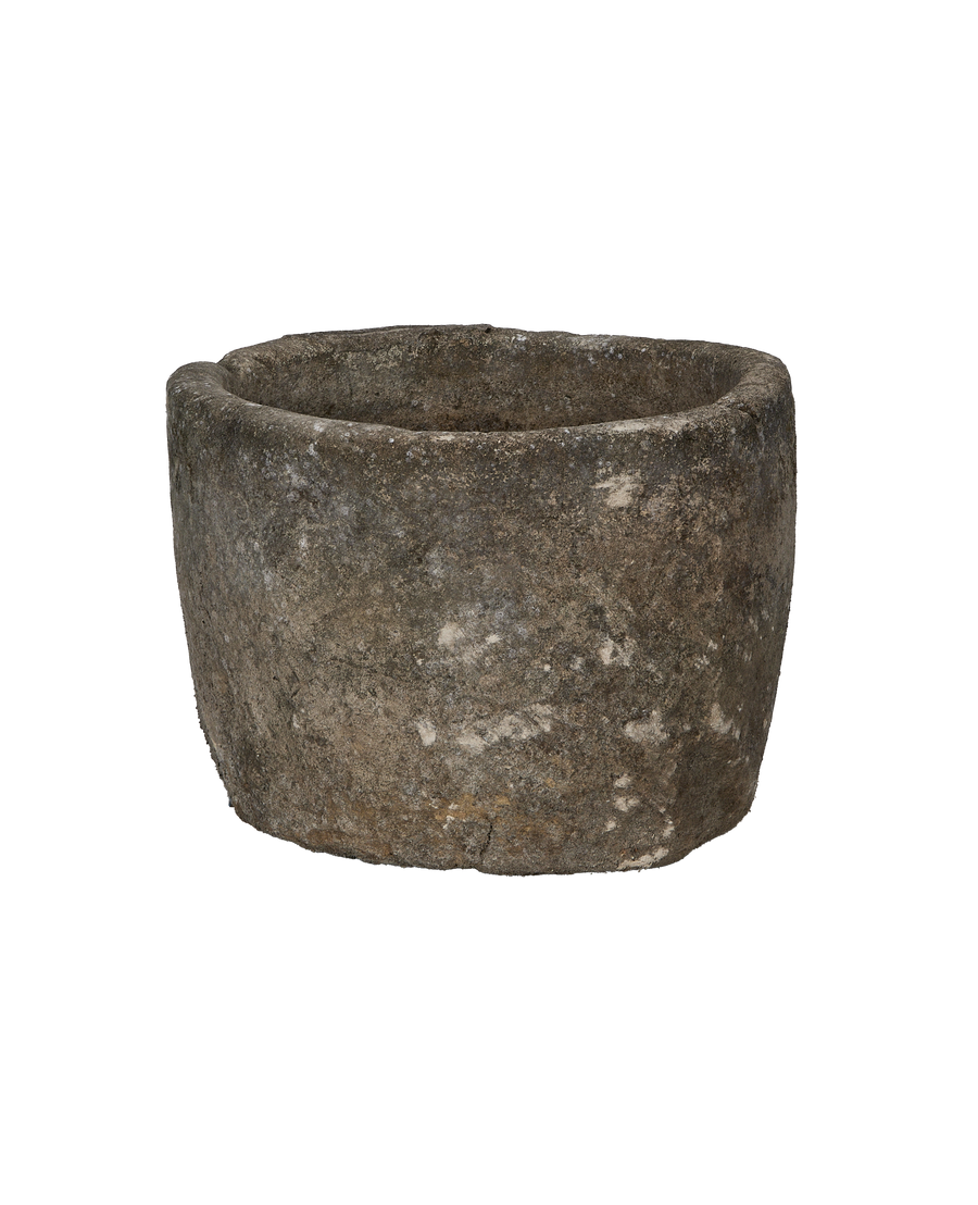 Vintage Indonesian round limestone trough, showing weathered texture, unique side angle.