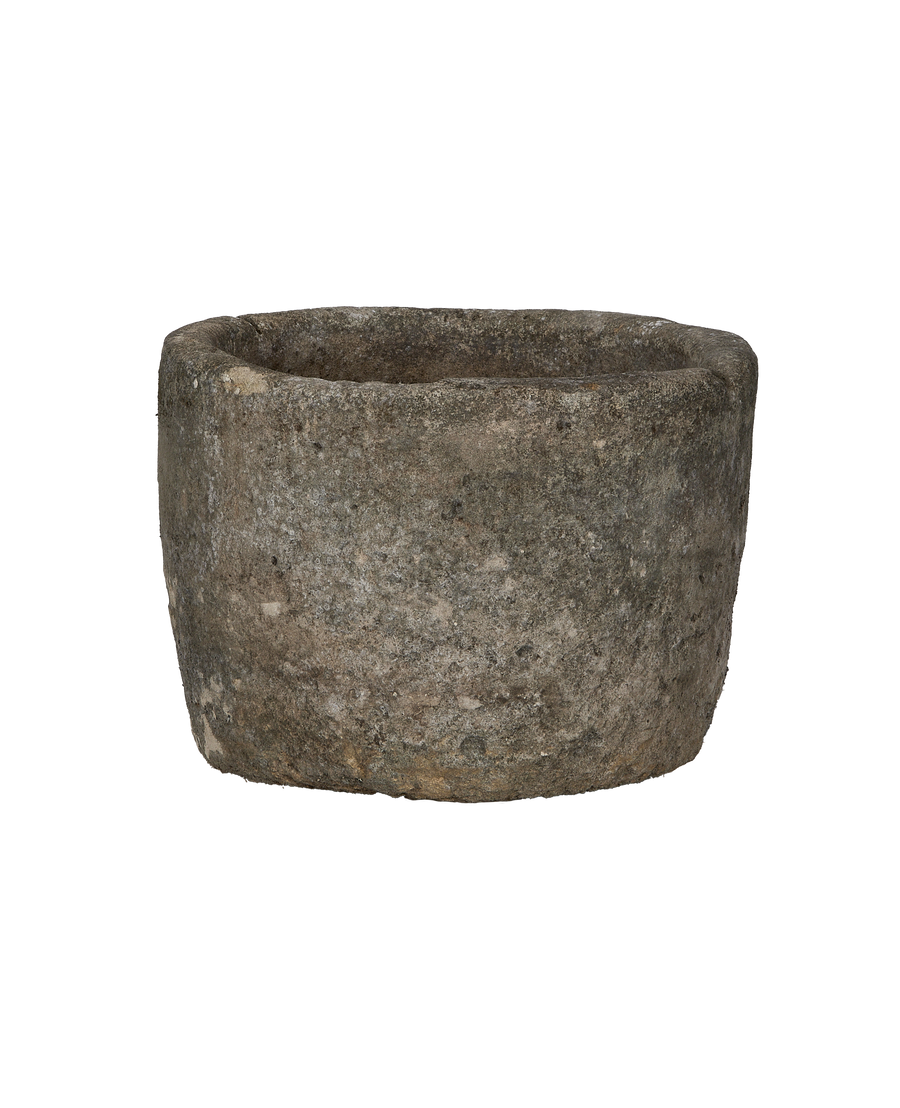 Vintage Indonesian round limestone trough, close-up of textured surface and rim, good condition.