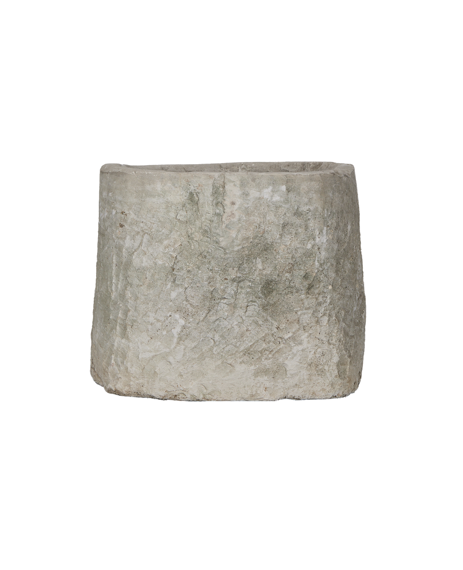 Vintage Indonesian round limestone trough, showing a side view of its rustic, textured surface.