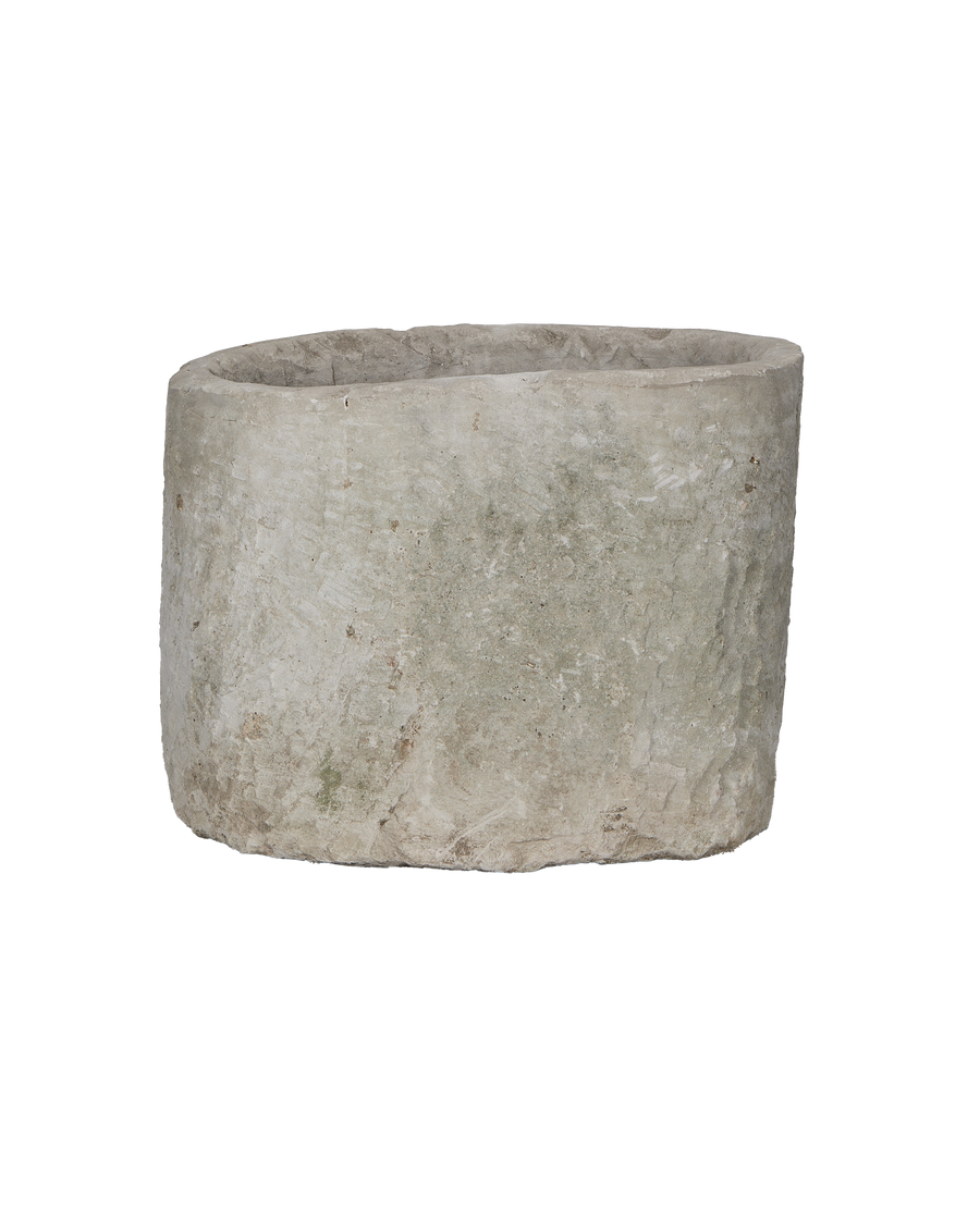 Vintage Indonesian round limestone trough, showing weathered texture from slightly elevated angle.