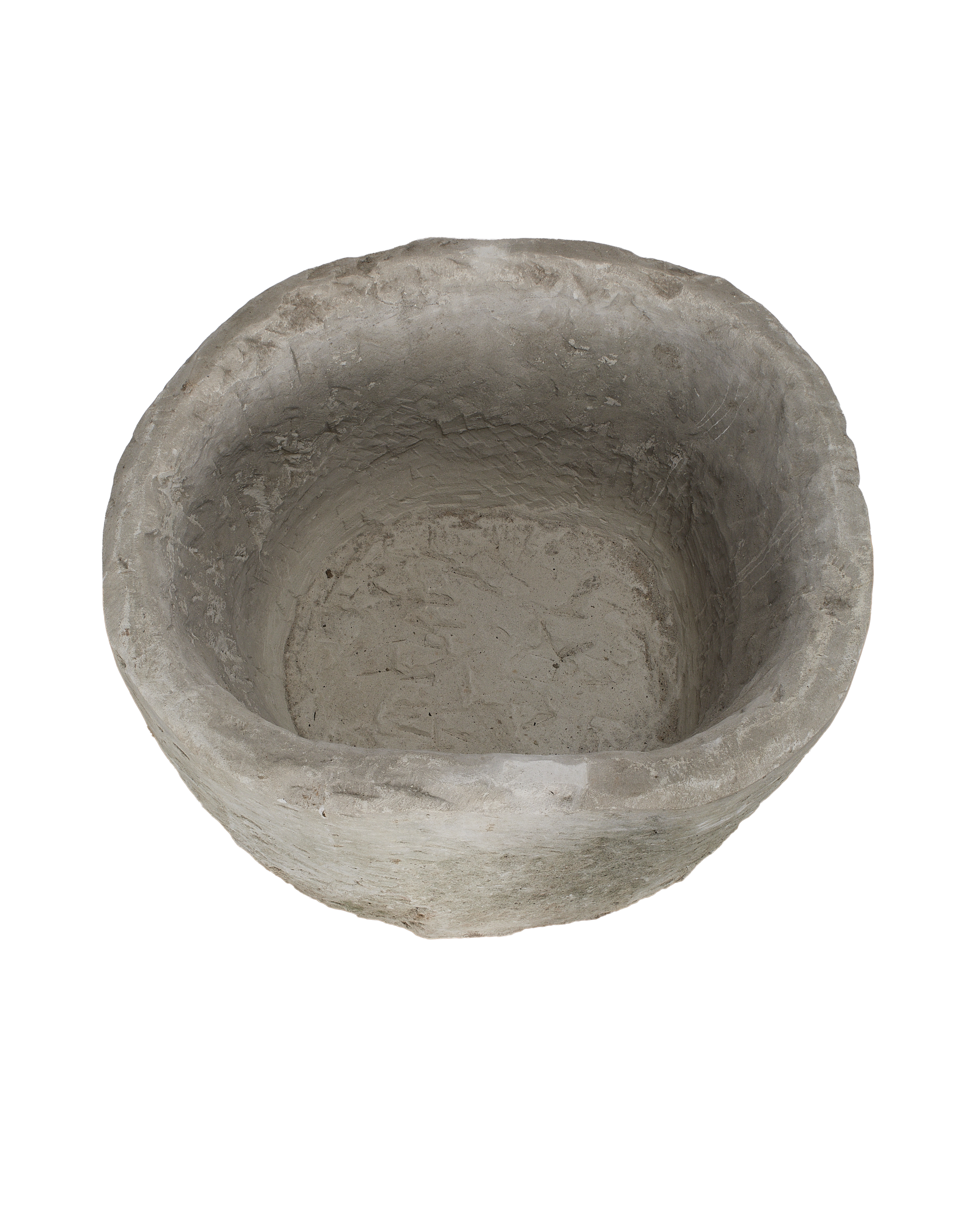 Vintage Indonesian round limestone trough, top-down view highlighting uneven texture and internal depth.