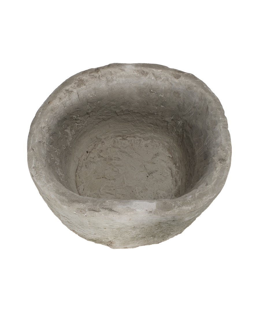 Vintage Indonesian round limestone trough, top-down view highlighting uneven texture and internal depth.