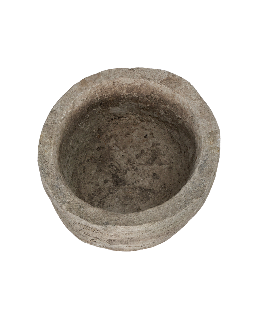 Vintage limestone round trough from above, showing rough weathered texture inside and on rim.