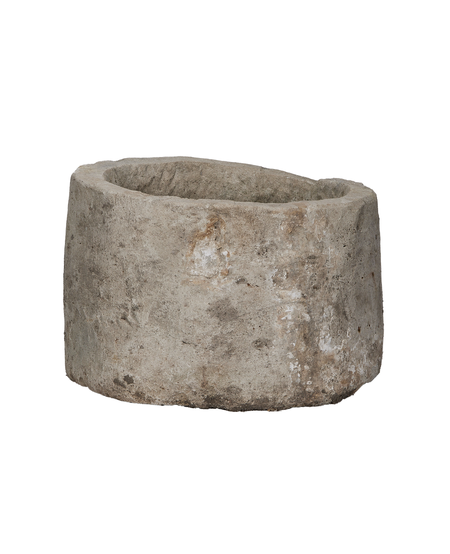 Vintage Indonesian round limestone trough, side view, showcasing weathered texture and unique organic rim.