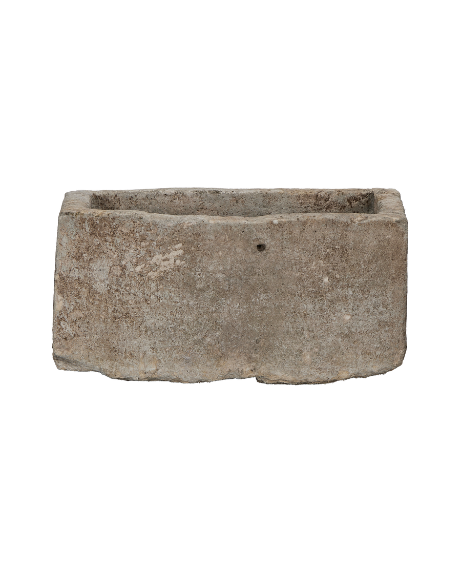 Vintage Indonesian rectangular limestone trough showing rough textured exterior, and interior rim.