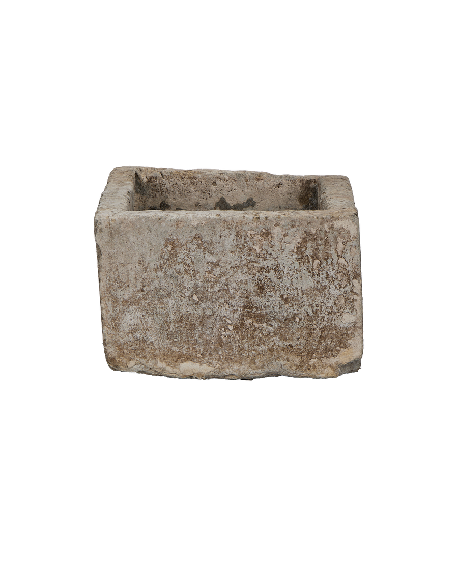 Vintage Indonesian limestone trough (Oak), showcasing rustic texture on its weathered, rectangular side.