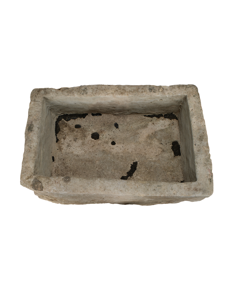 Rectangular vintage Indonesian limestone trough, top view showing weathered interior with dark patina.