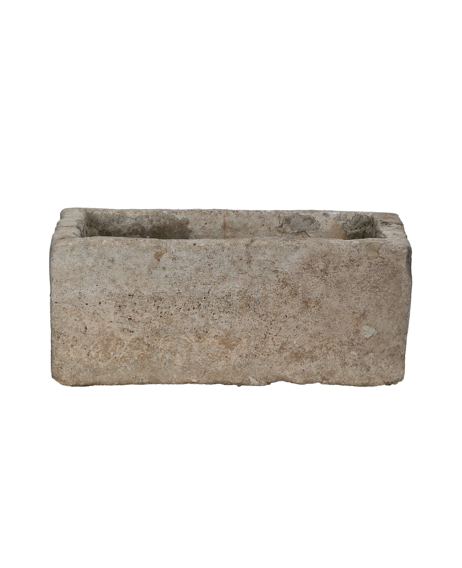 Vintage Indonesian limestone rectangular trough, showing textured side and aged, worn rim details.