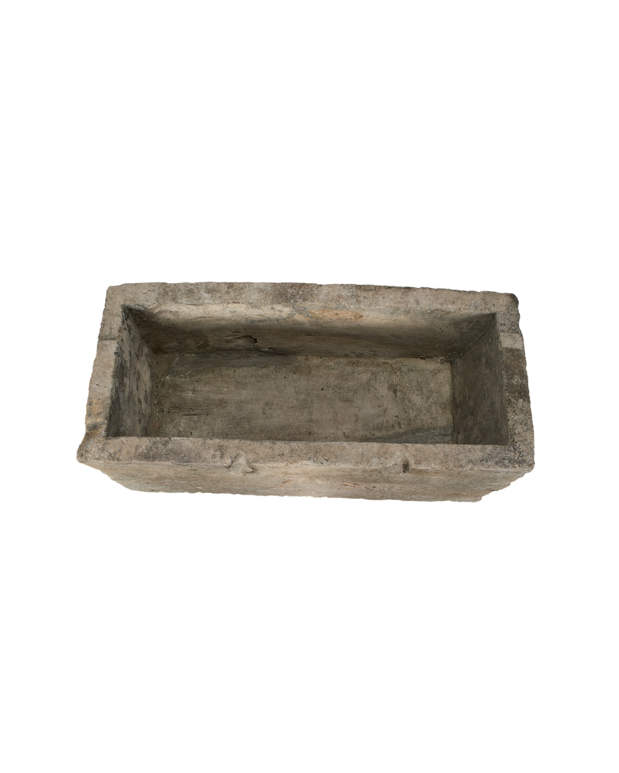 Vintage, rectangular Indonesian limestone trough, top-down view showing interior depth and rough texture.