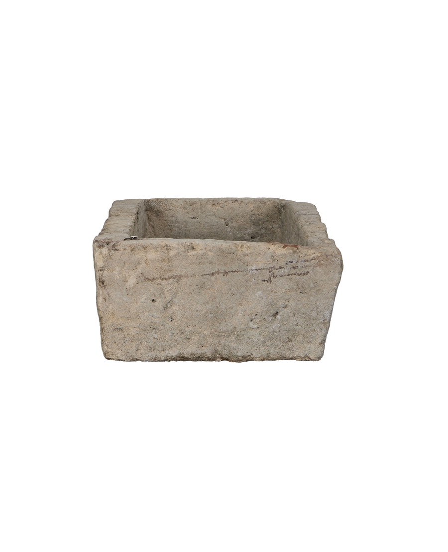 Vintage rectangular limestone trough, showing the rustic texture and weathered interior from above.
