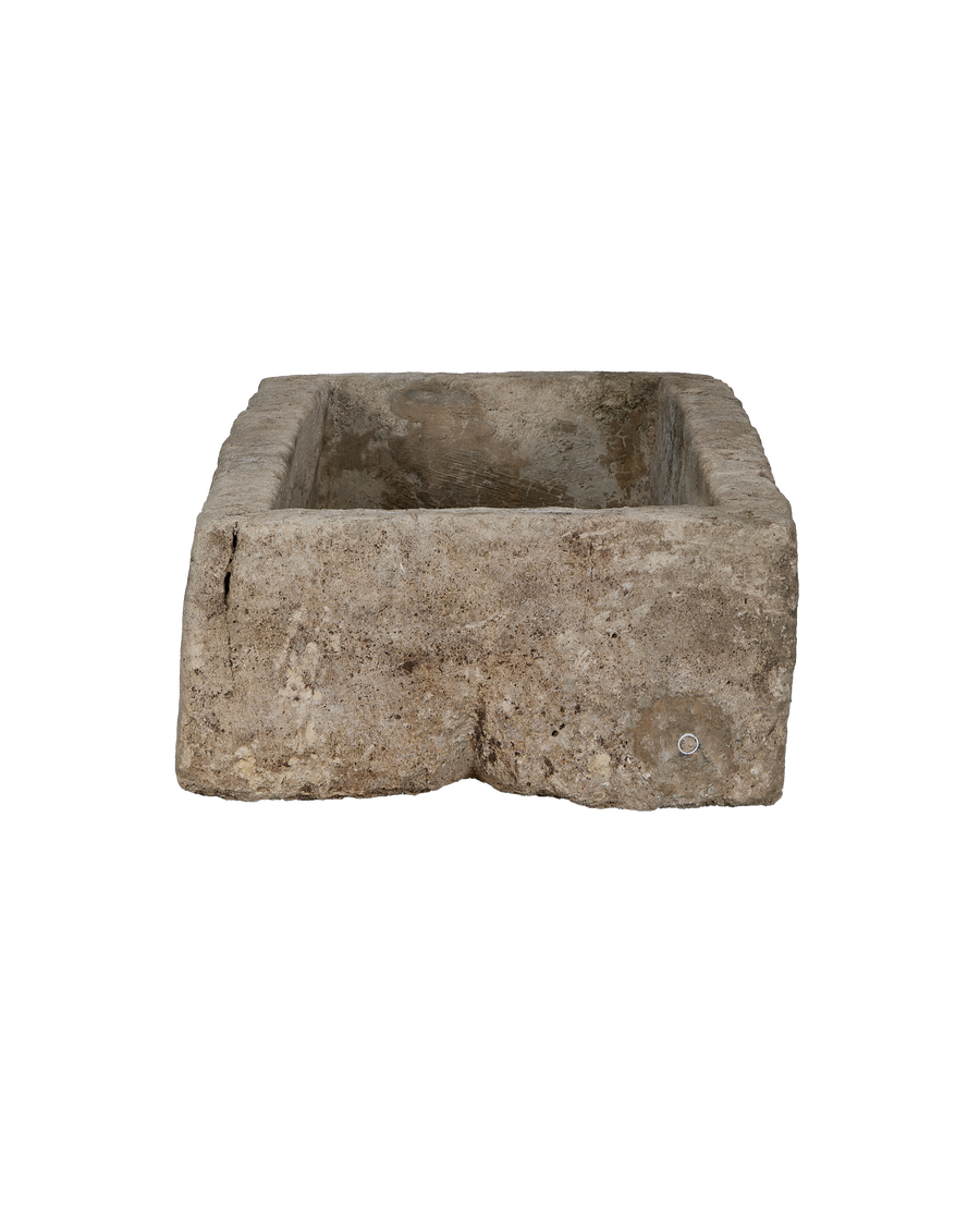 Weathered vintage limestone trough from Indonesia, showcasing rough texture and aged patina surfaces.