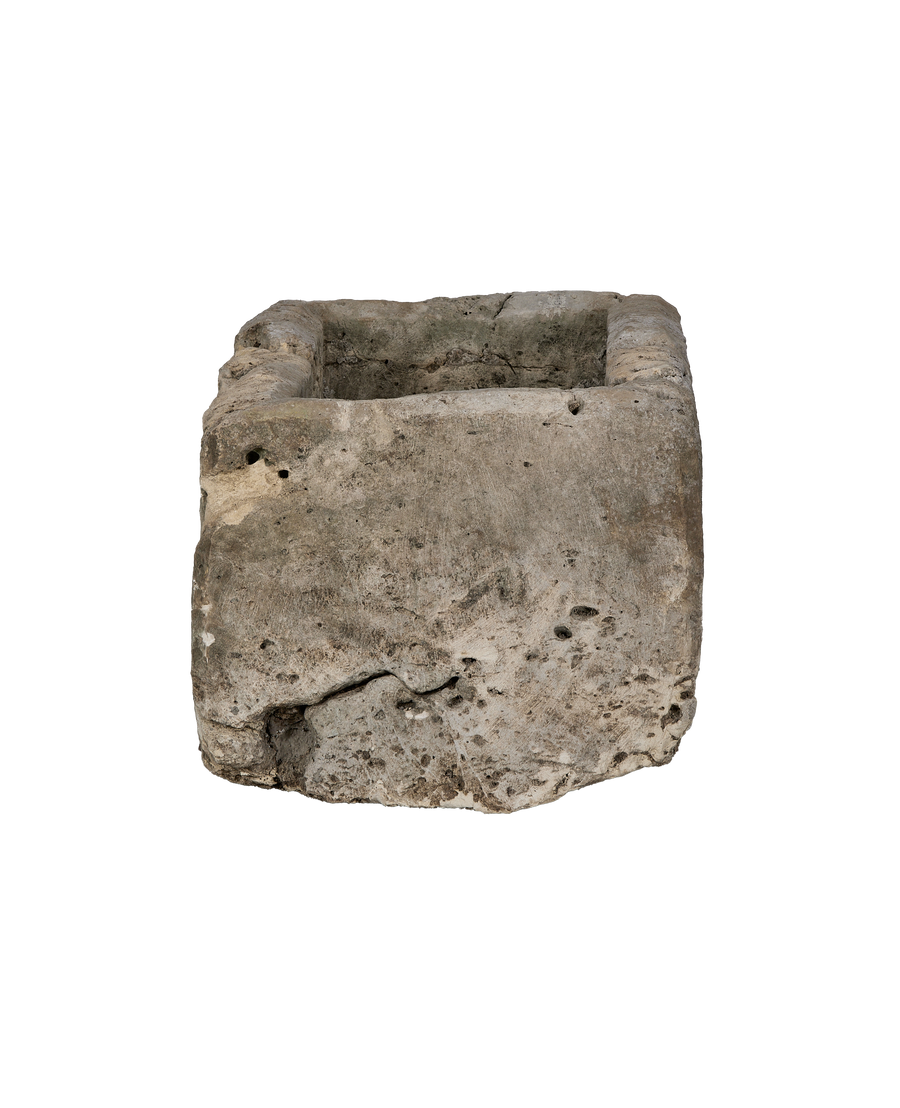 Vintage Indonesian limestone trough, displaying natural rough texture and aged cracks on its side.