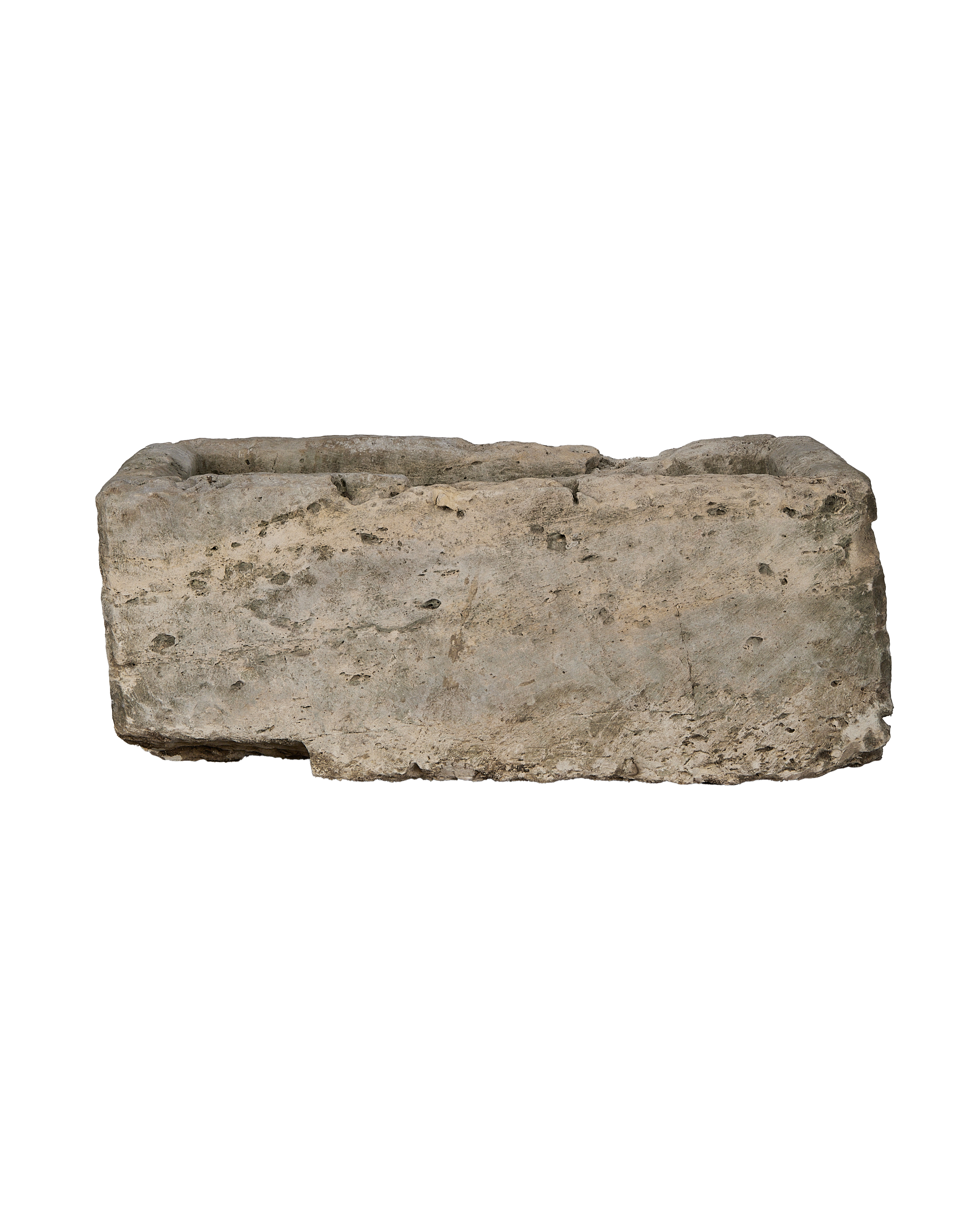 Vintage rectangular limestone trough, showing rough exterior with natural pitting and worn edges.