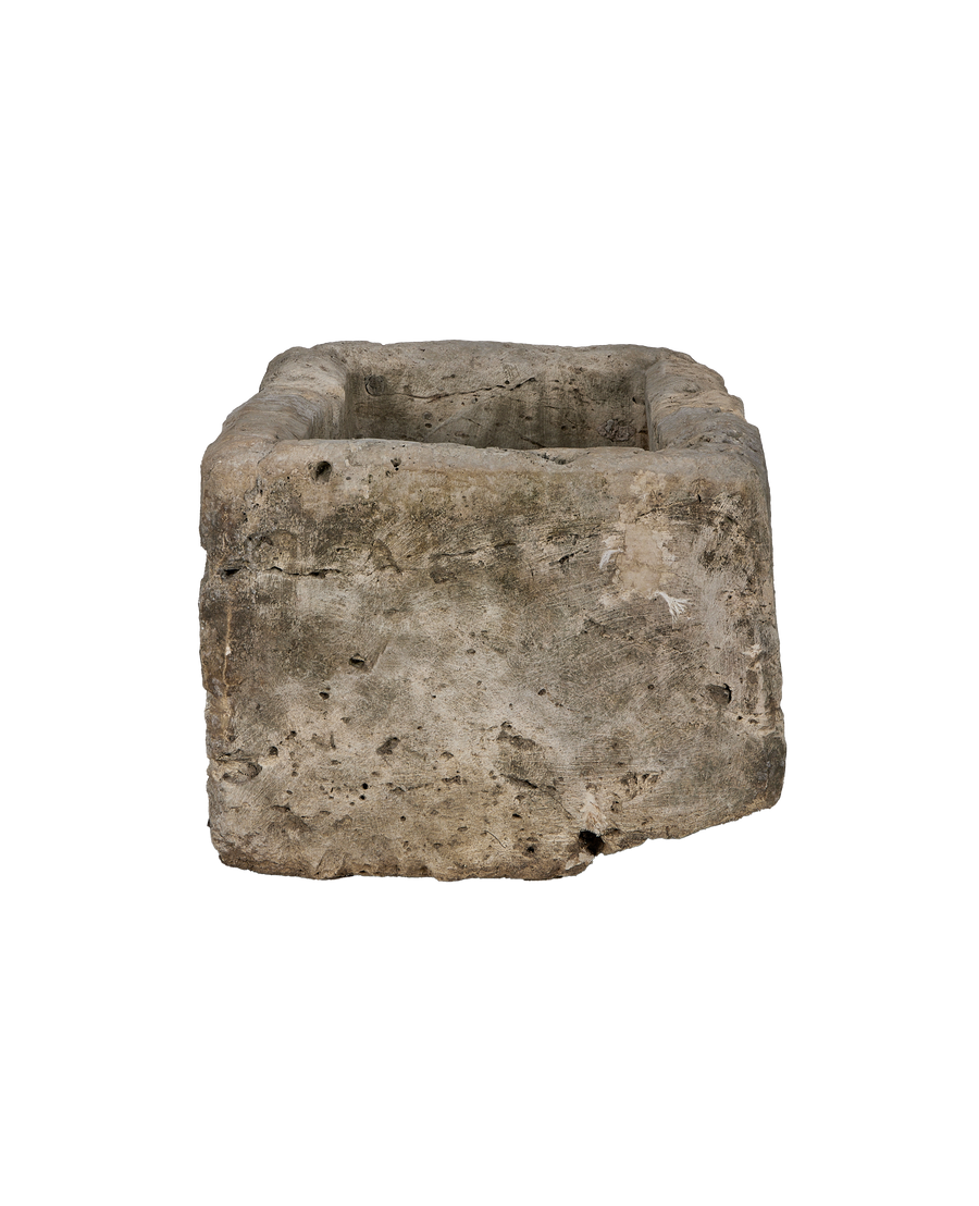 Vintage Indonesian limestone trough, detailed side view, rough texture, weathered patina.