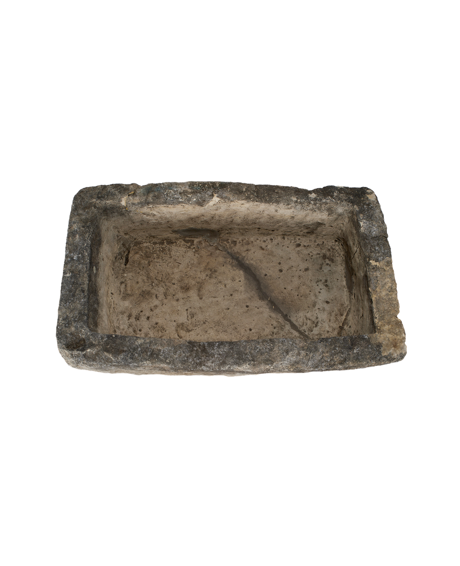 Vintage Indonesian limestone trough, top view revealing rough rectangular shape and weathered interior.