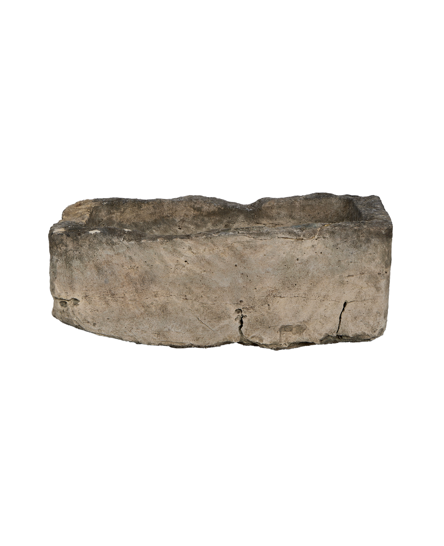 Vintage Indonesian rectangular limestone trough showing rough textured exterior and cracks.