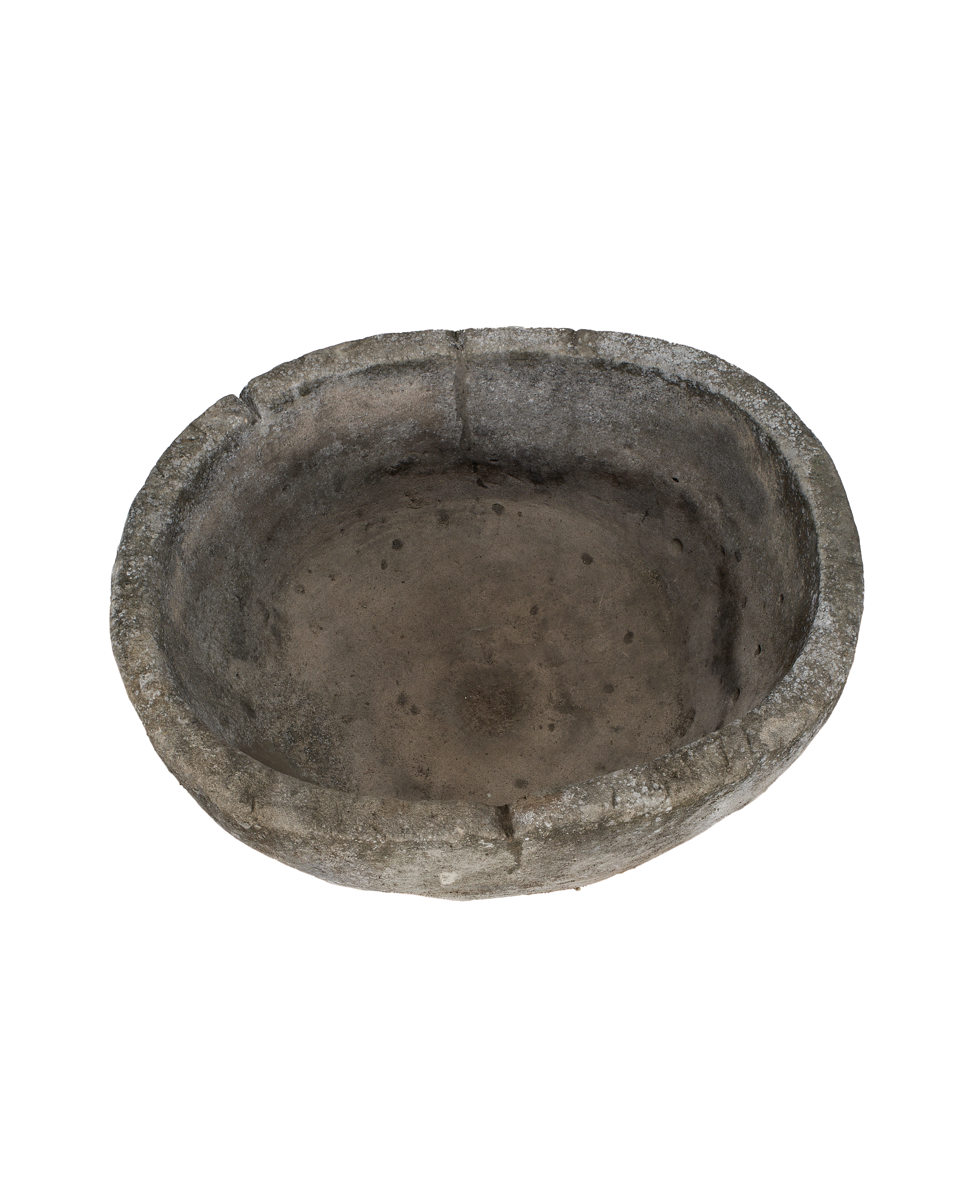 Overhead view of vintage Indonesian round limestone trough's weathered, textured interior.