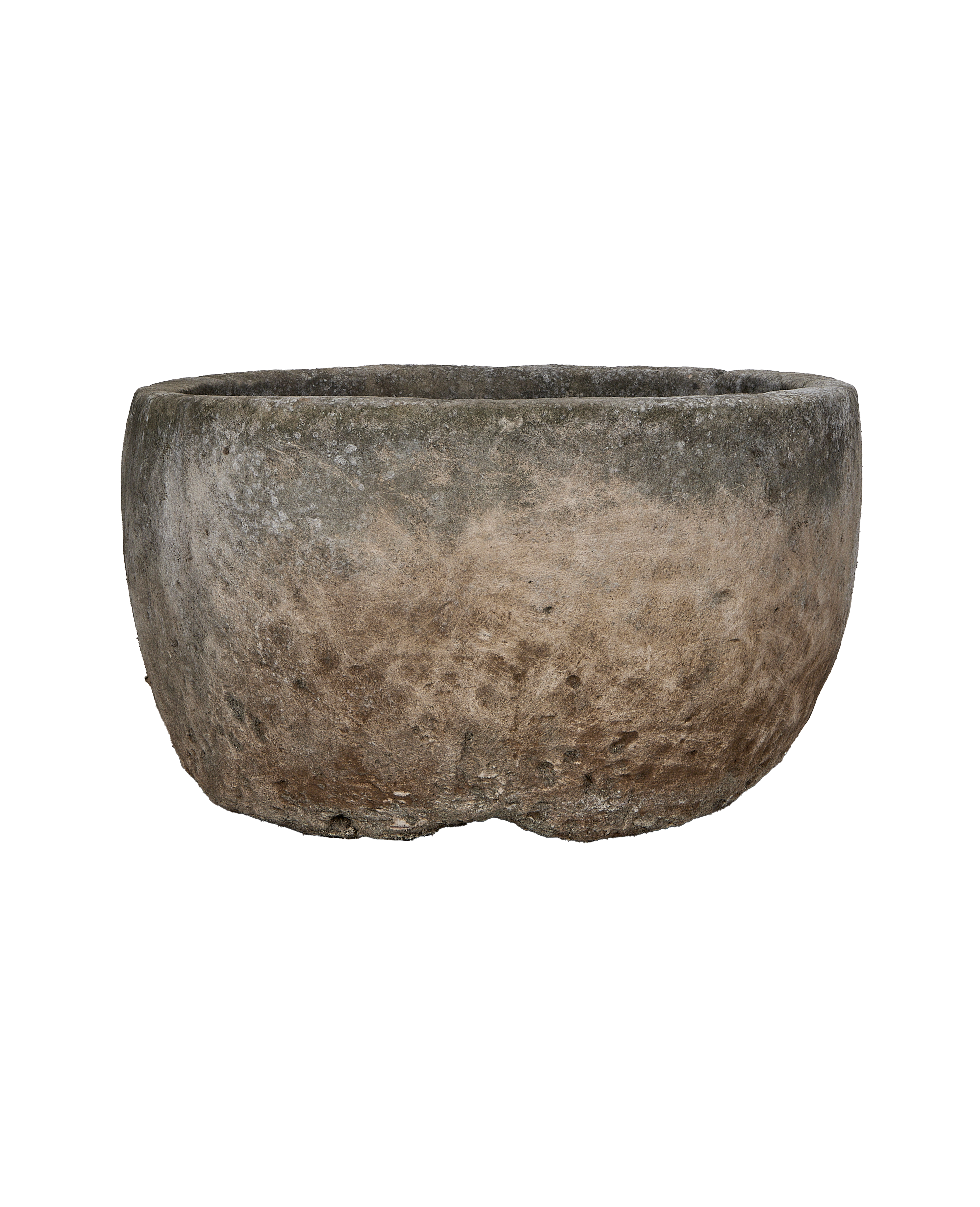 Vintage Indonesian limestone trough showcasing weathered texture and rounded shape from a side angle.