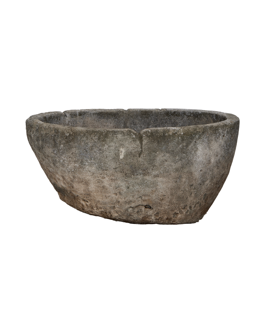 Vintage Indonesian round limestone trough, showing surface texture and rim detail.