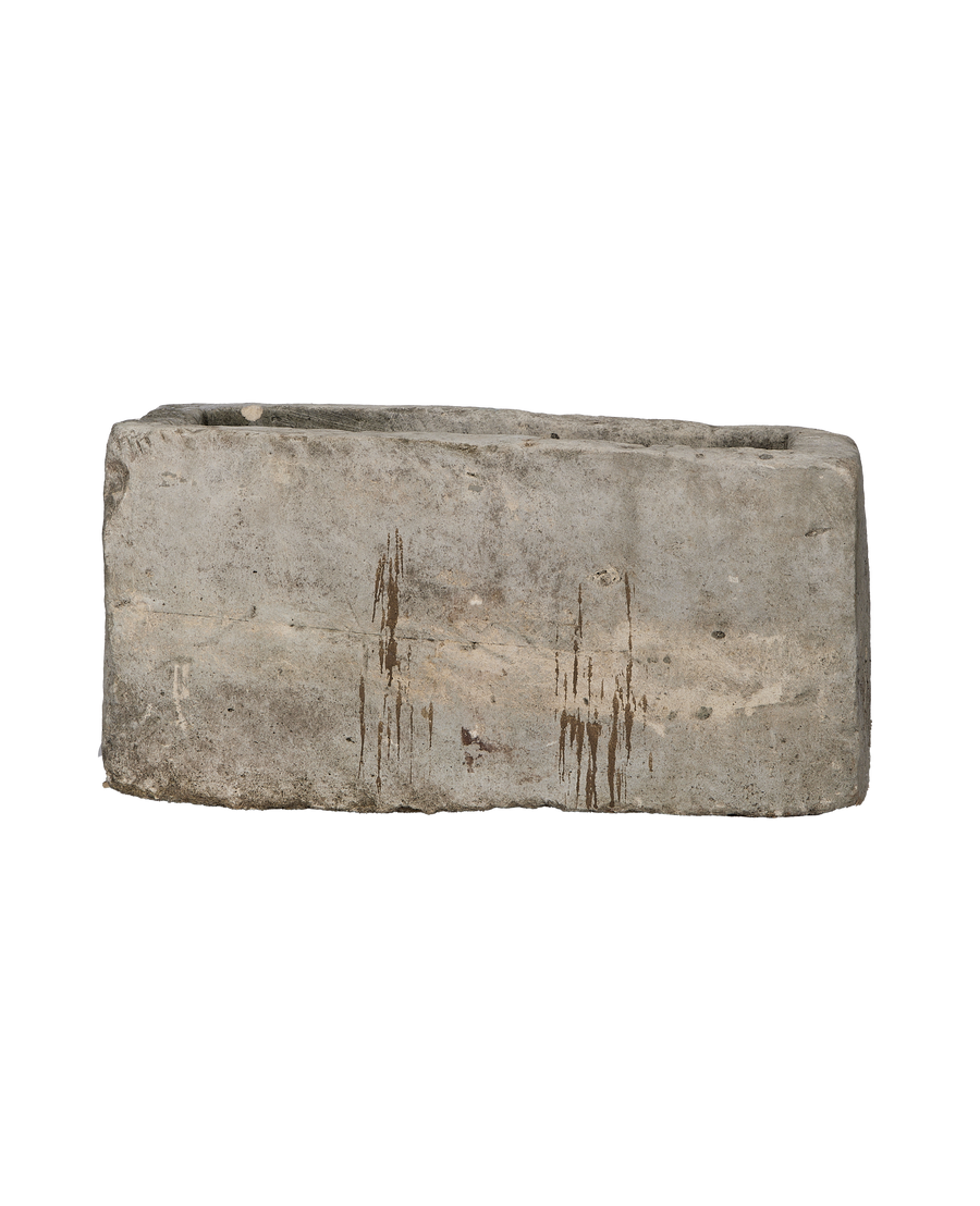 Vintage rectangular limestone trough, side view revealing rustic texture and brown streaking patina.